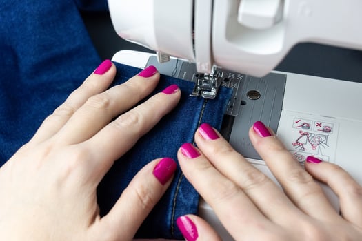Hands on the sewing machine photo