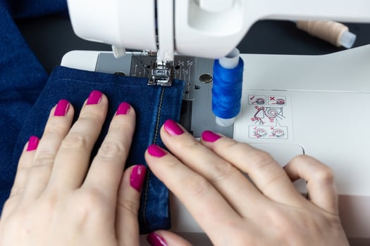 Hands on the sewing machine photo