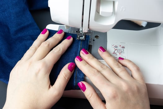 Hands on the sewing machine photo