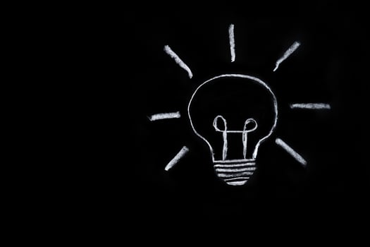 Light bulb on black background photo