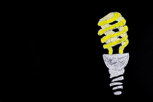 Light bulb on black background photo