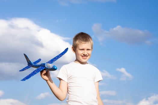 Boy with airplane sky background photo