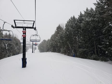 chairlift at a ski resort on a snowy day photo