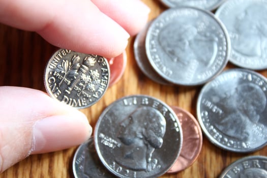 Dollar coins and dollar bills scattered on a wooden table, flat lay dollar coins. photo