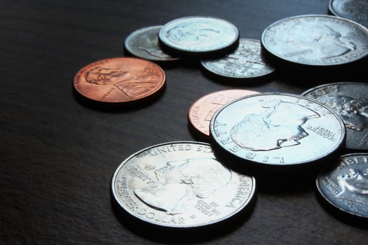 Dollar coins scattered on a wooden table, photo