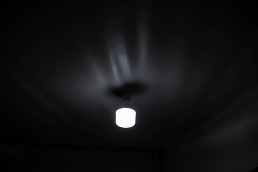 Lamp on ceiling. Dim light in room. Lighting device. photo
