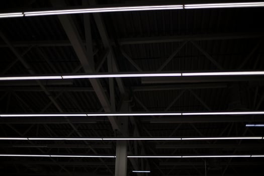 Lamp on ceiling. Light in dark room. Lamp is in interior. photo