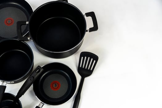 cookware set, steel dinner set isolated on white background, black metal cookware set photo