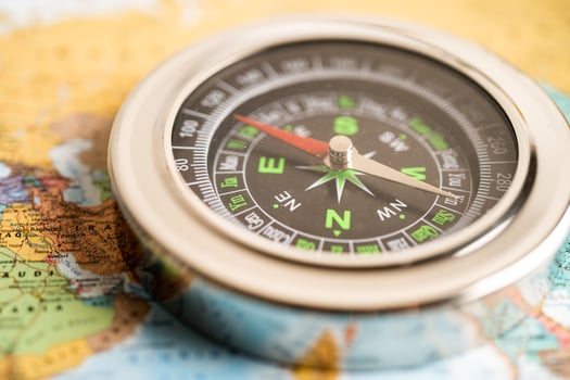 Bangkok, Thailand - January 20, 2022  Compass for navigation on  world map background to travel, geography, tourism and exploration concept. photo