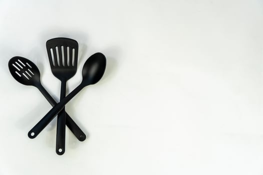 black plastic kitchen utensils isolated on white. Clipping path included. mexico photo
