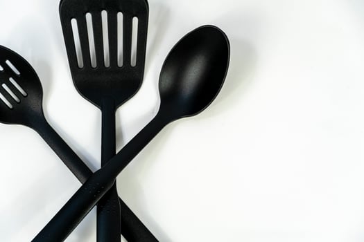 spatulas and spoons black plastic on white background, mexico photo
