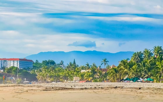 Palms parasols sun loungers beach resort Zicatela Puerto Escondido Mexico. photo