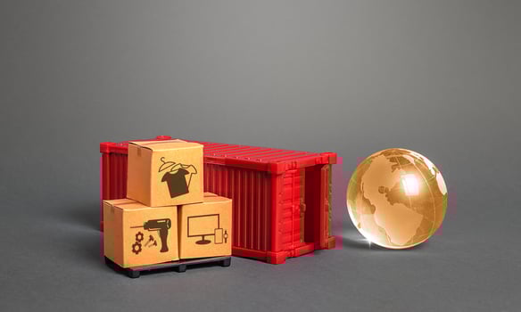Orange globe, cardboard boxes and red freight ship container. International world trade. Deliver goods, shipping. Import export traffic. Delivery goods under closed borders, quarantine restrictions. photo