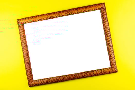 Wooden frame yellow background photo