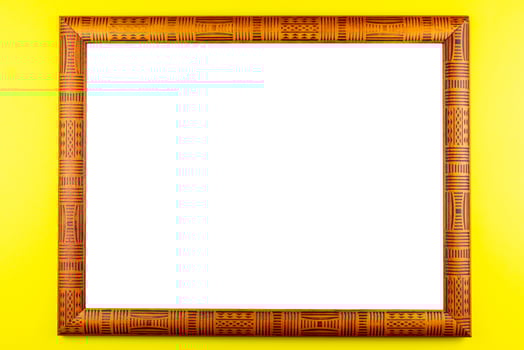 Wooden frame yellow background photo