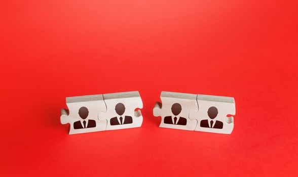Two unconnected groups of puzzles with people. Merging into a single team or splitting to form new ones. Restructuring department, staff management optimization. Consolidation business companies photo