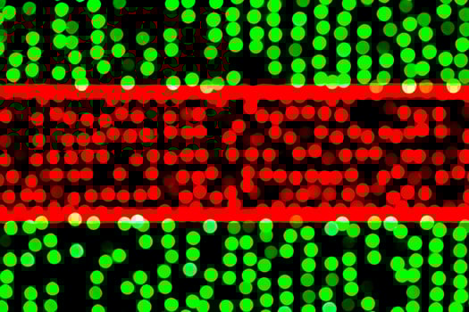 Unfocused abstract green and red bokeh on black background. defocused and blurred many round light photo
