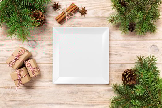 white square plate on a wooden table. with christmas decoration, square empty dish. New Year concept photo