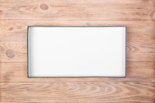 Opened cardboard box on wooden background. top view photo