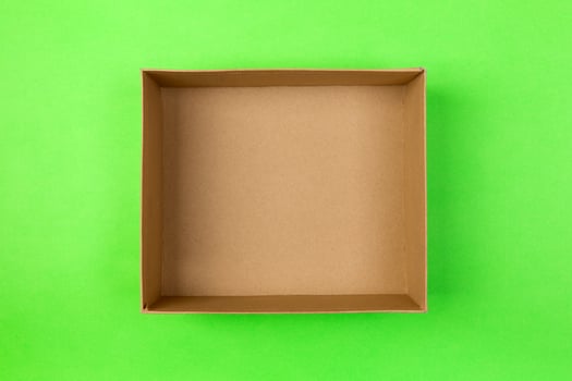 empty cardboard paper box on green background. delivery concept, top view photo