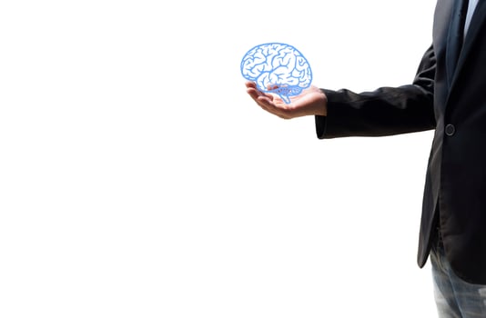 A man holding a brain illustration against a white wall background Concept of mental health protection and care. photo