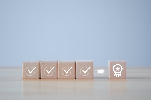 Checklist and sign of the top service Quality assurance on wooden blocks. Guarantee, Standards, ISO certification, standardization concept, advertising product and service quality commitment. photo