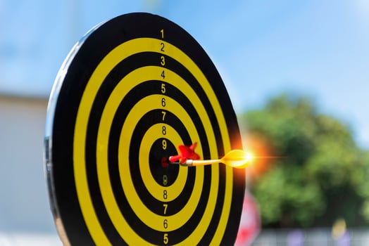 Two dart hit it's target on a red background, concept for success,darts motion blur. photo