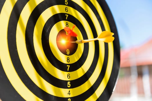 Two dart hit it's target on a red background, concept for success,darts motion blur. photo