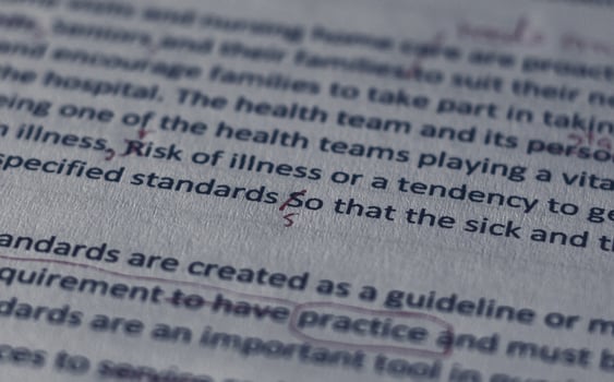 handwriting marking error on English letter on draft paperwork photo