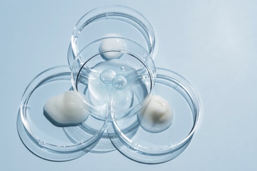medicine, cosmetic research, bio science, testing organic skin care products. Petri dishes on blue background. Top view, flat lay. Concept skincare. Dermatology. photo