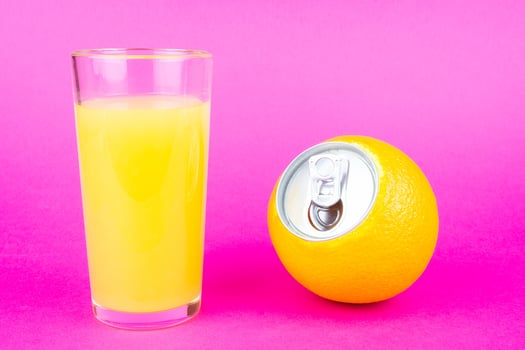 Orange juice on pink background photo