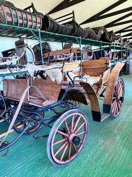 an old fashioned carriage is in a warehouse photo