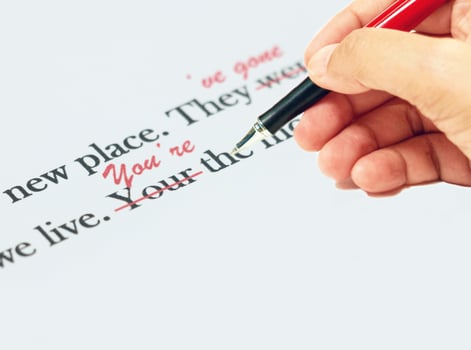 proofreading of English sentences on white paperwork photo
