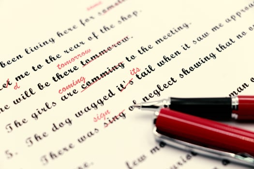 proofreading of English sentences on white paperwork photo