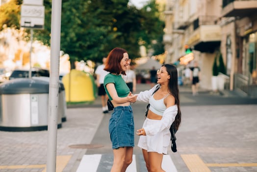 Happy meeting of two friends hugging in the street photo