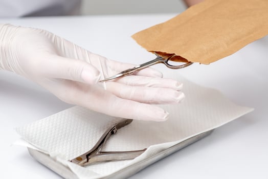 Manicurist hands taking manicure tools photo