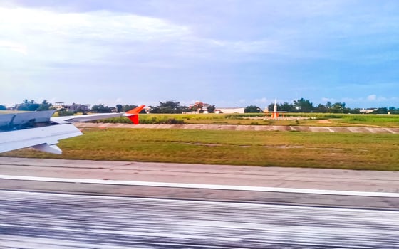 Plane landing on coast Puerto Escondido view from window Mexico. photo