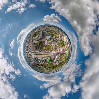 tiny planet in sky with clouds overlooking old town, urban development, historic buildings and crossroads. Transformation of spherical 360 panorama in abstract aerial view. photo
