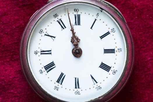 vintage pocket watch on red velvet close up photo