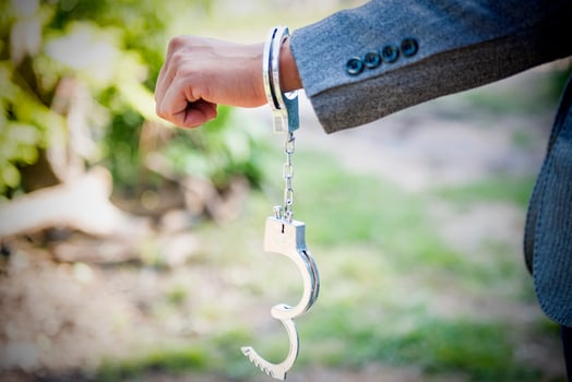 hand release shackle The man's handcuffs were opened. acquitted innocent defendant gray suit businessman cessation of criminal proceedings. photo