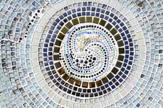Colorful of mosaic tile floor for background. Art design wallpaper, Cracked, Shape or circle or round and Abstract. Blue, gray or grey, black, white and brown and blue tile fragments on wall. photo
