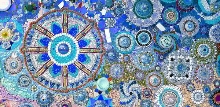 Colorful of blue wall decorated with multicolor stone, gravel and gem for background at Wat Phra That Pha Son Kaew. Abstract of art design with broken tile for wallpaper. photo