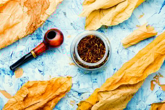 Smoking pipe with tobacco leaves,top view photo