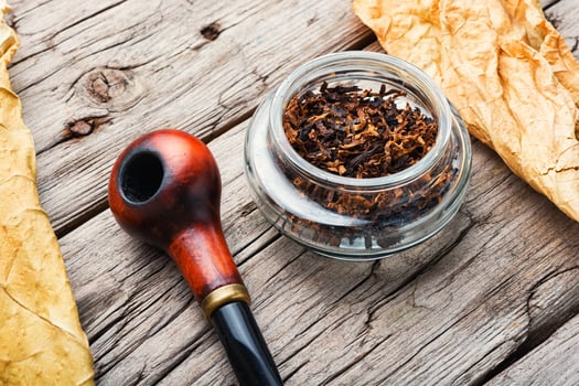 Smoking pipe with tobacco leaves photo