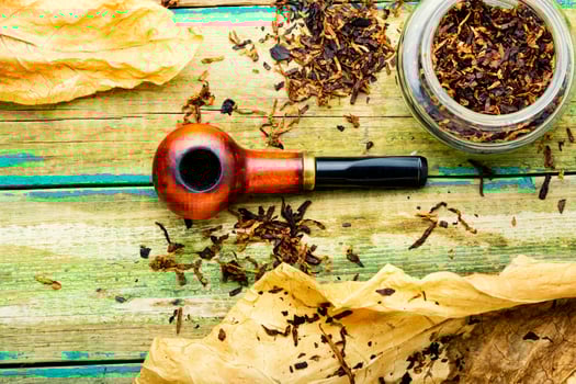 Smoking pipe with tobacco leaves,top view photo