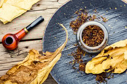 Smoking pipe with tobacco leaves,top view photo