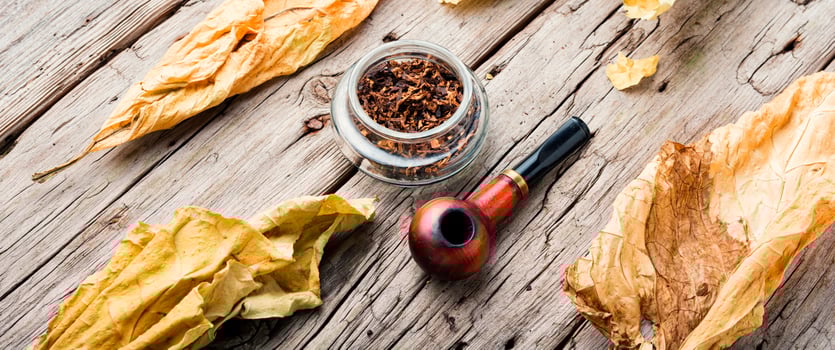 Smoking pipe with tobacco leaves photo