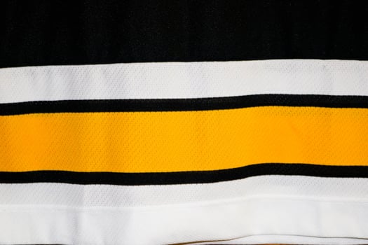 Texture of a multi-colored white yellow black synthetic German fabric. The background photo