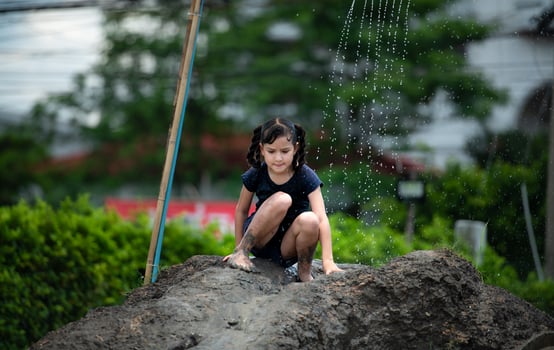 Childrens have fun playing mud slides in the community fields. photo