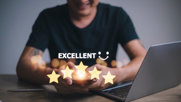 customer hand with gold five star rating feedback icon and press level excellent rank for giving best score point to review the service, business concept photo